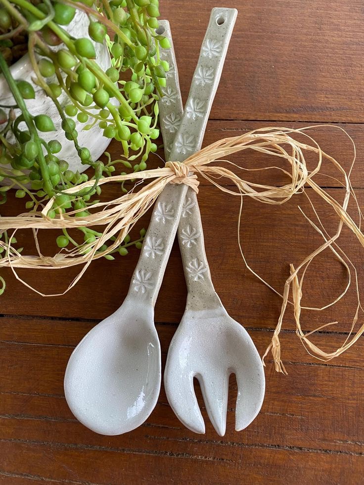 Handmade ceramic salad servers tied with raffia